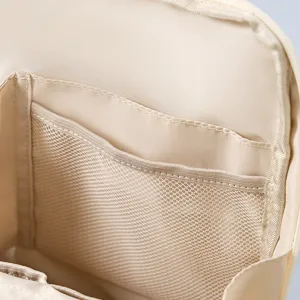 Beige travel cosmetic bag interior detail showing mesh pockets and multi-compartment storage.