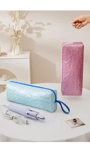 Close-up detail of travel hair styling tool storage bag with cute heart quilted design.