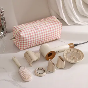 Portable hair dryer storage bag set with multiple styling nozzles and professional hair brush.