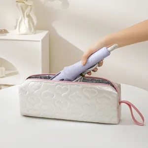 White quilted storage bag for hair styling tools with pink zipper and heat resistant lining