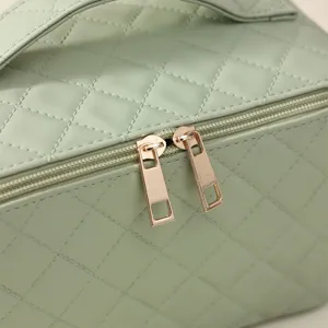 Light green quilted cosmetic bag large capacity portable makeup organizer travel vanity case.