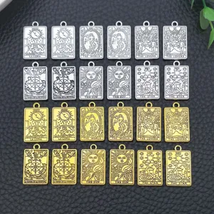 Detail shot of square tarot card metal pendants in gold and silver, DIY jewelry findings.