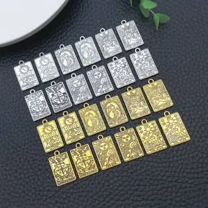 Close-up detail shot of various gold and silver metal square tarot card pendants for DIY jewelry.