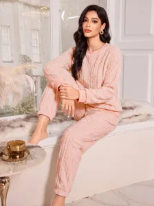 Pink fuzzy fleece pajama set for women, featuring cozy cable knit long sleeves and warm pants.