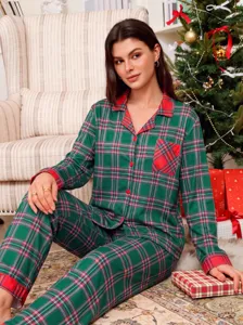 Close-up view of the red and green plaid long-sleeve loungewear set in a festive setting.