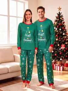 Cozy matching Christmas pajama detail shot featuring festive tree print and soft green fabric.