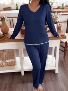Detailed lifestyle view of cozy navy blue long sleeve V-neck pajama set for homewear.