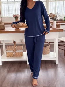 Detailed view of women's long-sleeve V-neck loungewear set in dark blue, casual home wear.