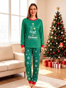 Christmas pajama set detail featuring green graphic top and festive snowflake pants.