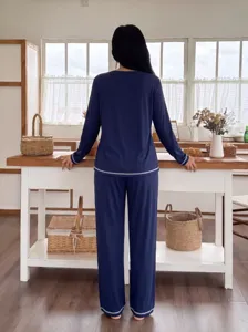 Cozy dark blue long sleeve pajama set showcased in a warm home kitchen interior scene.