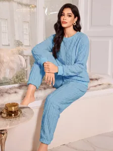 Cozy light blue fleece loungewear set for women, soft thermal long sleeve top and pants.