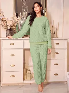 Detailed view of women's cozy fleece loungewear set featuring long sleeves and cuffed pants.