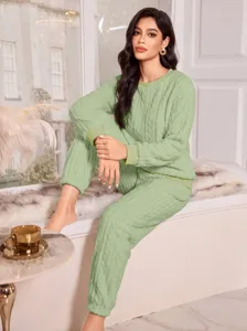 Detailed view of women's cozy winter light green coral fleece loungewear set, long sleeve.