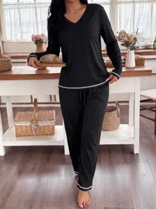 Casual women long sleeve V-neck pajama set in black with contrast piping for cozy nights.
