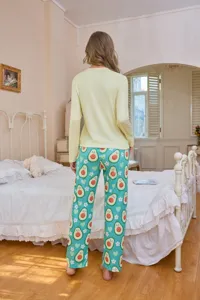 Cozy bedroom lifestyle scene showcasing cute avocado print long sleeve set details.