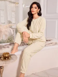 Cozy coral fleece pajama set for women, thick warm long sleeve top and cuffed pants.
