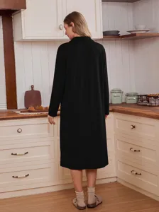 Detailed view of the comfortable black long sleeve casual sleepwear cardigan in a home kitchen scene.