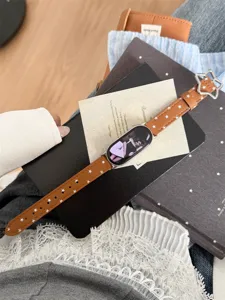 Vue détaillée du bracelet de montre en cuir marron avec étoiles blanches et boucle étoile.