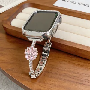 Elegant bracelet de montre metallique avec strass compatible Apple Watch et fleur en cristal.