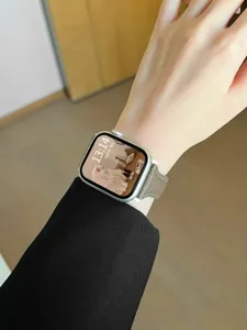 Close-up detail of slim genuine leather watch strap on wrist, elegant design and fine stitching.