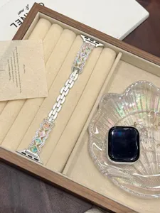 Metal watch strap compatible with Apple Watch, featuring elegant colorful cubic stone design.