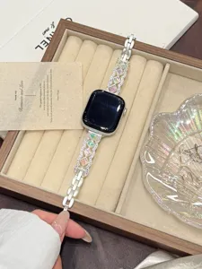 Metal watch strap detail featuring colorful square stones and wave design for Apple Watch.