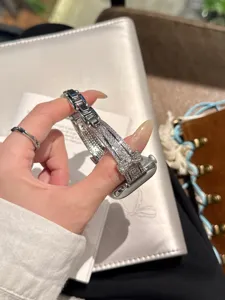 Sparkling rhinestone bow watch band detail, elegant silver metal sparkling accessory.