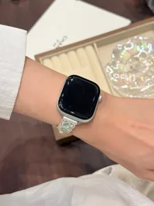 Detailed shot of metallic wave stone watch strap worn on wrist, exquisite jewelry design.