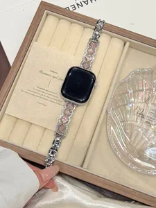 Detailed view of metal rhinestone watch strap with pink square stones for Apple Watch.