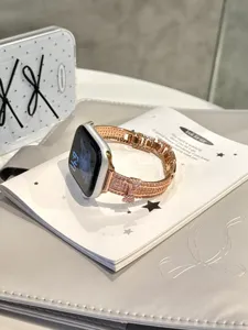 Rose gold pavé diamond watch strap detail with bow, compatible with Apple Watch series.