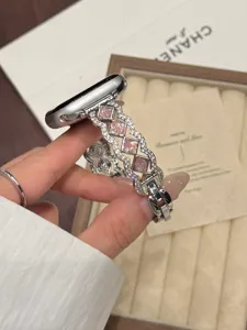 Metal watch band compatible with Apple Watch, featuring pink stone and wave design.