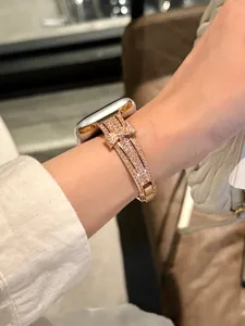 Detailed view of sparkling rhinestone bow metal watch band compatible with Apple Watch.