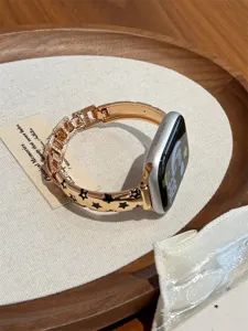 Bracelet de montre en métal doré avec motifs d'étoiles noires, compatible Apple Watch.