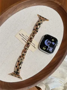Vue détaillée du bracelet de montre en métal acier, design creux étoile or rose pour montre connectée.