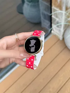 Detailed shot of a red silicone smartwatch strap featuring cute white hearts and a custom dial.