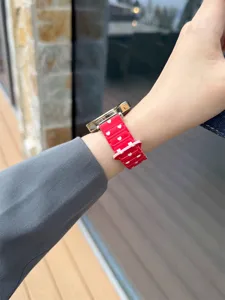Red silicone watch strap with cute white heart pattern, stylish waist design for smartwatch.