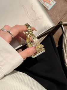 Gold rhinestone bow Apple Watch band detail shot, sparkling crystal metal strap replacement.