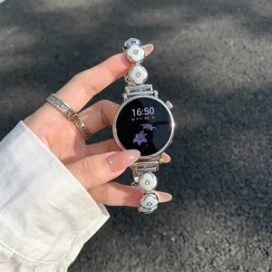 Close-up of clover metal smartwatch strap, elegant replacement band with chic charms.