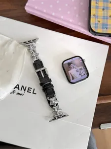 Bracelet de montre en cuir noir élégant pour Apple Watch avec breloques étoiles argentées.