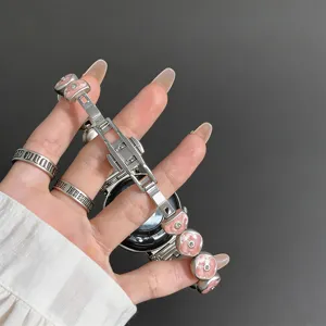 Metal watch strap with pink enamel clover charms, compatible with smartwatches, stylish accessory.