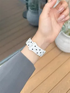 White silicone watch strap featuring black heart patterns, wrist detail view accessory.