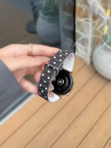 Detailed view of black silicone watch strap with white heart pattern, flexible link design.