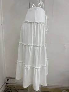Casual white tiered maxi skirt with elastic drawstring waist and elegant lettuce edge details.