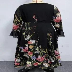Back detail of plus-size floral long sleeve dress with flare cuffs and elegant ruffle hem.
