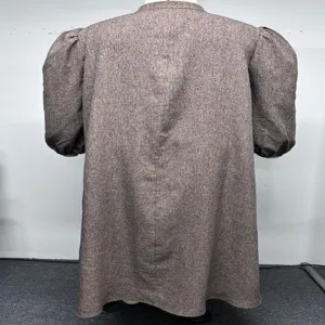Detailed back view of the loose brown tweed dress showing the vintage bubble long sleeves.