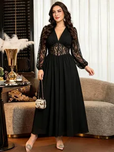 Elegant black plus-size dress featuring sheer lace long sleeves, V-neck, and boned waist.