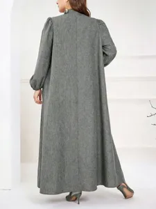 Plus size long sleeve stand collar loose maxi dress detail view showing textured fabric and fit.