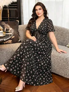 Close-up detail of the floral V-neck midi dress featuring chic lace waist and flutter sleeves.