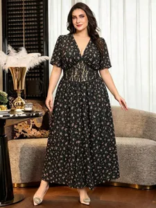 Detailed close-up view of the black floral maxi dress featuring lace waist insert and V-style.