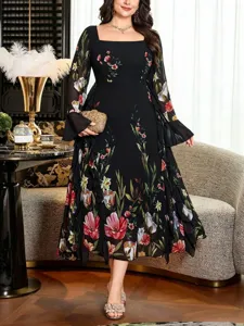 Detailed view of plus size black floral square neck long sleeve dress worn by model in luxurious setting.